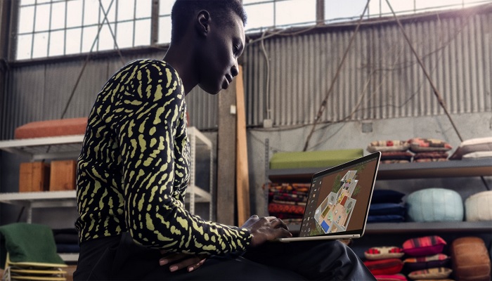 The image shows a person using the Apple Macbook Air M3. — Apple
