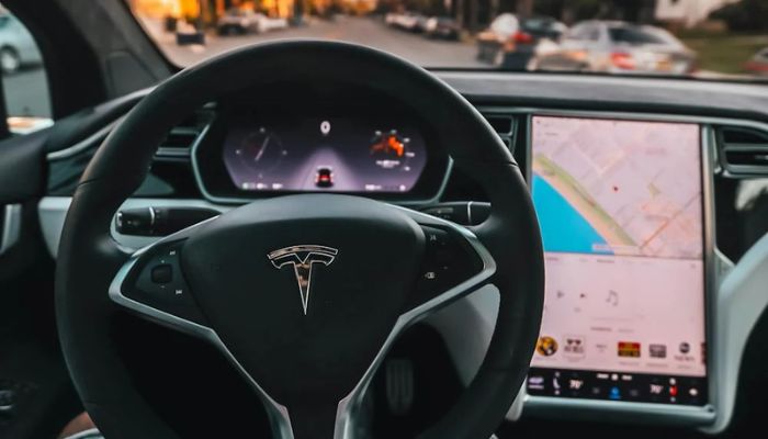 The image shows person inside a Tesla in Santa Monica, CA, United State. — Pexels