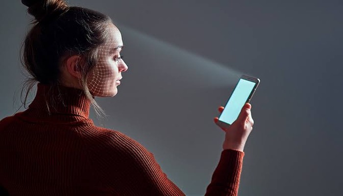 An Undated image of girl using face recognition on Smartphone. —Unsplash