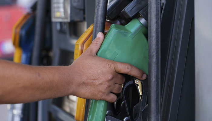 An undated image of a worker holding a nozzle to pump petrol into a vehicle at a fuel station. — Pixabay
