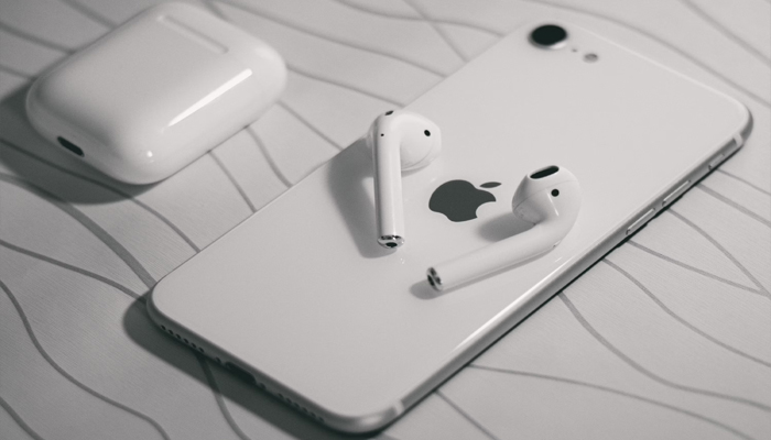 An undated image showing Apple Airpods along with iPhone X. — Unsplash