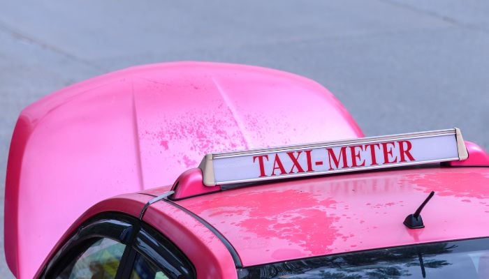 An undated image of a pink taxi. — Canva
