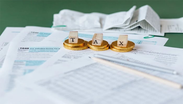 An undated image showing various documents along with TAX word. — Pexels