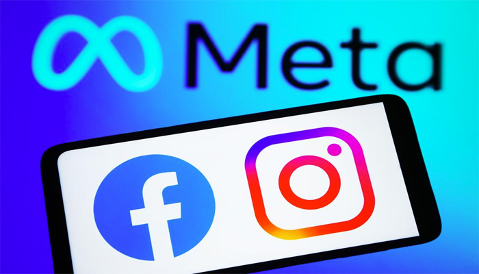 An undated image of Facebook and Instagram logo on smartphone, along with Meta logo in the background. — Getty Images