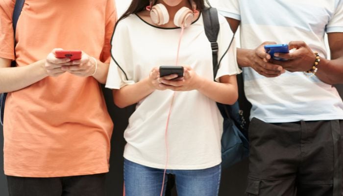 An undated image of people using smartphone. — Canva