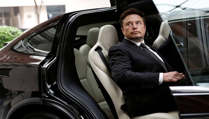 Tesla CEO Elon Musk gets in a Tesla car as he leaves a hotel in Beijing, China May 31, 2023. — Reuters