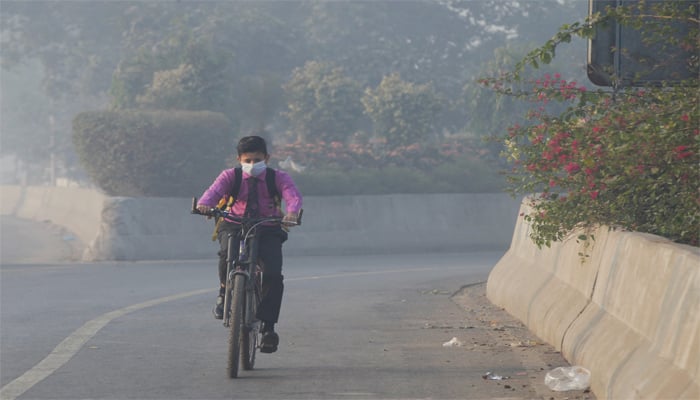 Student rides a bicycle to school amid dense smog in Lahore, Pakistan November 24, 2021. — Reuters