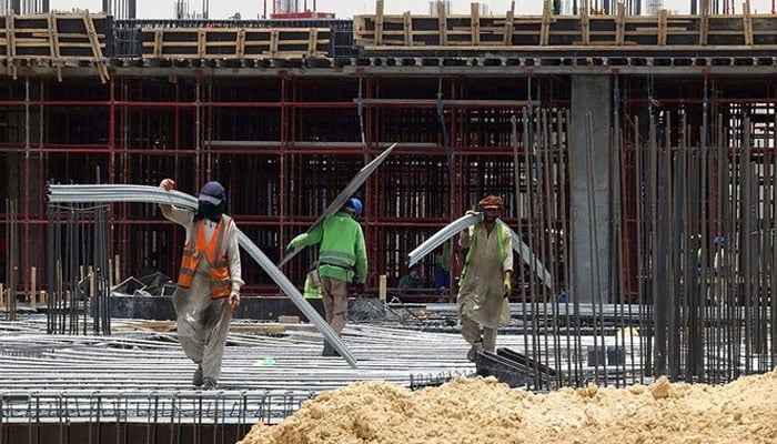 An undated image showing labourers working at a construction site in Rawalpindi. — AFP