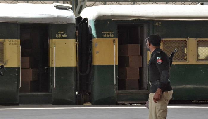 A security force personnel member stands guard near a train containing empty coffins that are dispatched to Bolan where a passenger train that was attacked by separatist militants, at a railway station in Quetta, Pakistan, March 12, 2025. — Reuters