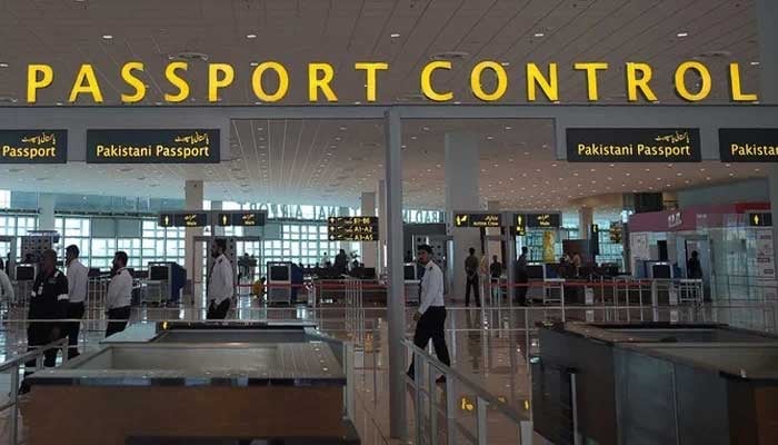 An image showing Pakistani airport staff walks through the Islamabad International Airport on the outskirts of Islamabad, taken on April 26, 2018. — AFP