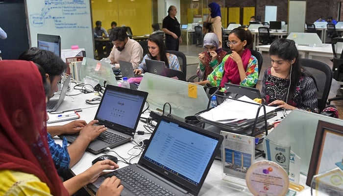 The image shows people working at their stations at an incubation centre in Lahore. — AFP/File