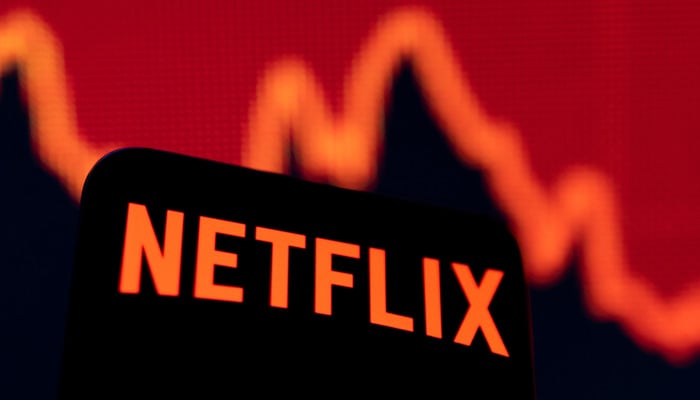 Smartphone with Netflix logo is seen in front of a descending stock graph in this illustration taken April 19, 2022. — Reuters