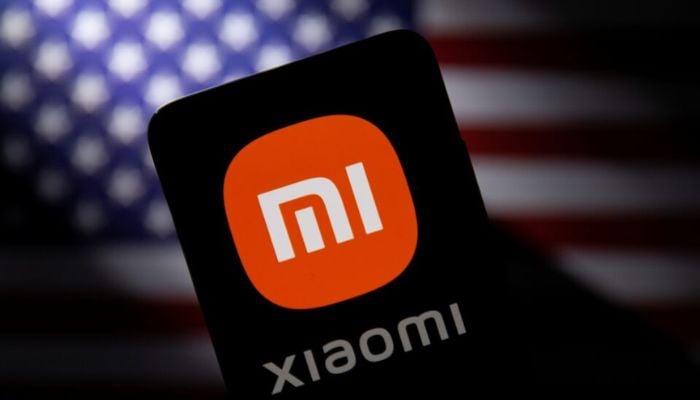 An image of a smartphone with a Xiaomi logo is seen in front of a US flag in this illustration taken September 28, 2021. — Reueters