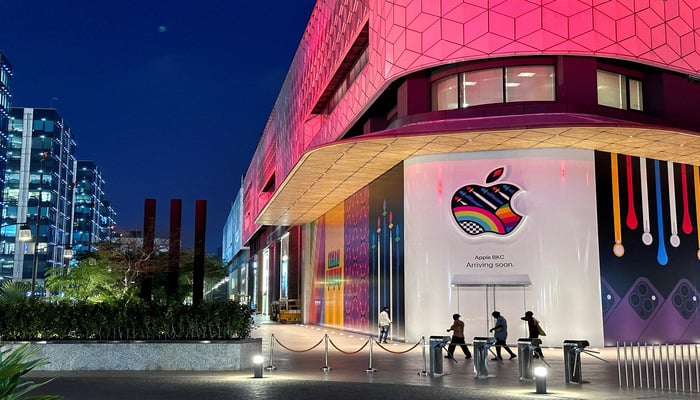 [1/4]People walk past the barricade of Indias first Apple retail store, that will be launched soon, at Jio World Drive Mall, Mumbai, India, April 5, 2023. — Reuters