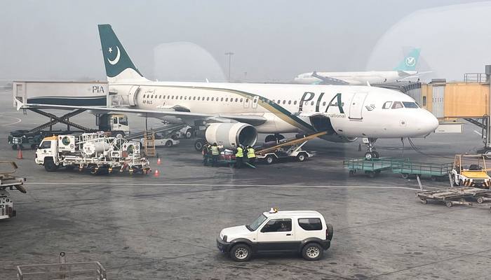 View of a Pakistan International Airlines (PIA) passenger plane, taken through a glass panel, at Islamabad International Airport, Pakistan October 3, 2023. — Reuters