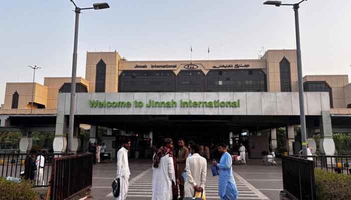 Passengers wait outside at Jinnah International Airport after all domestic and international flights were cancelled in Karachi, Pakistan, May 7, 2025. — AFP