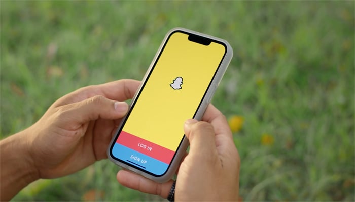 An undated image shows Snapchats log in interface on smartphone. — Snapchat