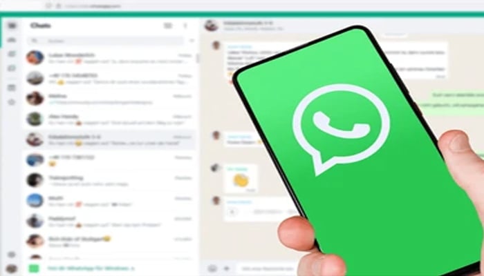 An undated image shows WhatsApp logo on smartphone and interface in background. — Shutterstock