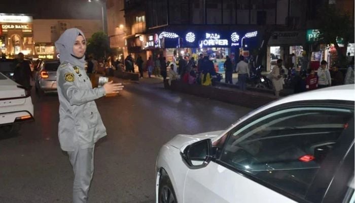 An image released on November 9, 2024, shows a lady officer of the Islamabad Traffic Police (ITP) regulating traffic in Islamabad. — Facebook@Islamabad Traffic Police