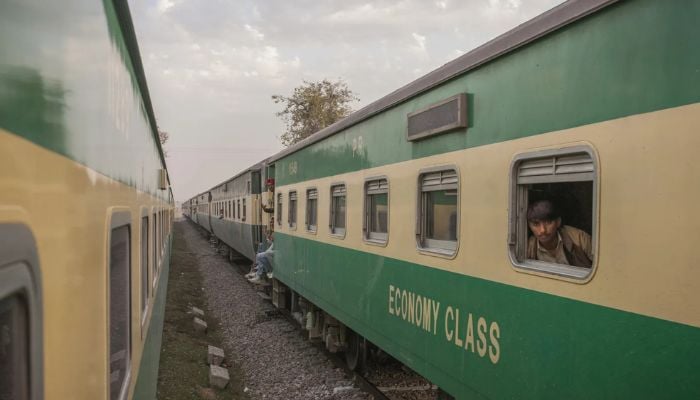 An undated image of passengers traveling on a standard Pakistan Railways economy coach are seen from the Green Line train service en route from Islamabad to Karachi. — Bloomberg