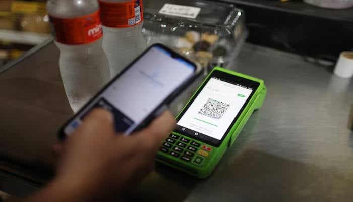 A person pays using their cell phone with the instant electronic payment mode known as PIX, at a store in Rio de Janeiro, Brazil April 1, 2024. — Reuters