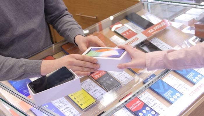 An undated image of a person buying phone. — Unsplash