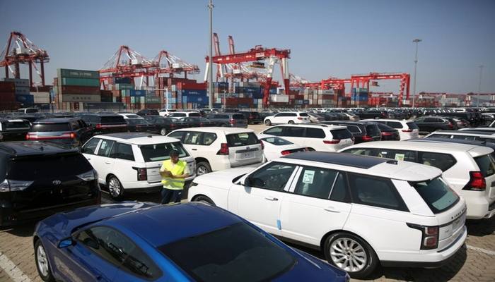 A worker inspects imported cars at a port in Qingdao, Shandong province, China May 23, 2018. — Reuters