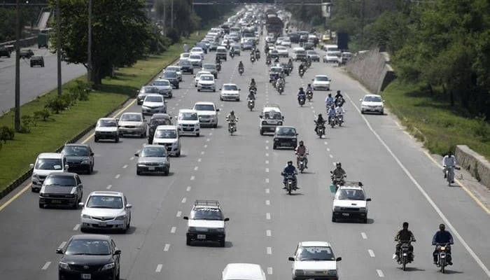 An undated image shows commuters making their way along a motorway as they enter capital city Islamabad. — AFP
