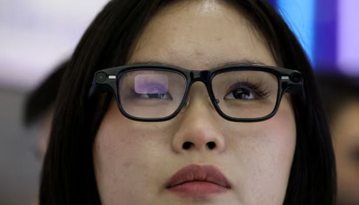 An image of a woman trying on a pair of Quark AI glasses by Alibaba at the companys booth at the World Internet Conference expo in Wuzhen town, Tongxiang city, Zhejiang province, China, on November 8, 2025. — Reuters