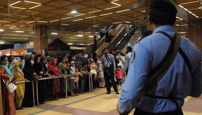 An undated image of a security force personnel standing guard at Jinnah International Airport in Karachi. — AFP