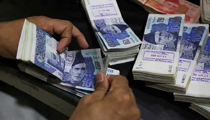 An employee counts Pakistani rupee notes at a bank in Peshawar, Pakistan August 22, 2023. — Reuters