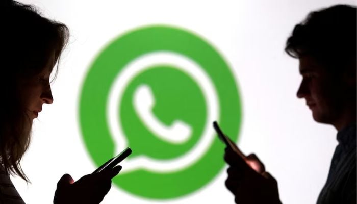 An image of teenagers posing for a photo while holding smartphones in front of a WhatsApp logo in this illustration taken September 11, 2025. — Reuters