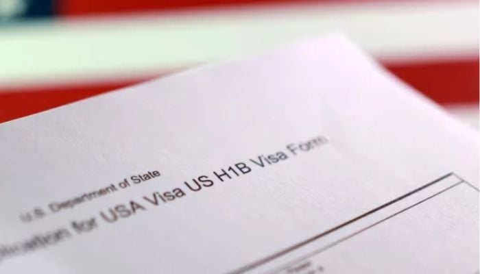 An image of US flag and a US H-1B visa application form is seen in this illustration taken on September 22, 2025. — Reuters
