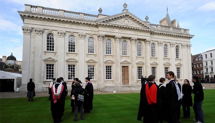 Graduates gather outside Senate House after their graduation ceremony at Cambridge University in eastern England. — Reuters