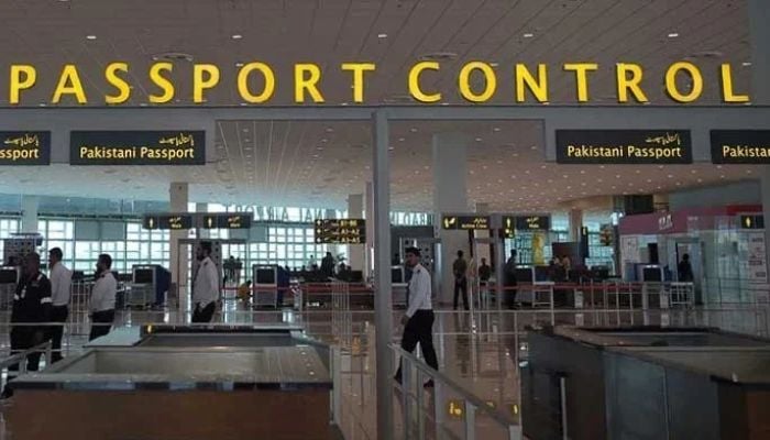 An image showing Pakistani airport staff walks through the Islamabad International Airport on the outskirts of Islamabad, taken on April 26, 2018. — AFP