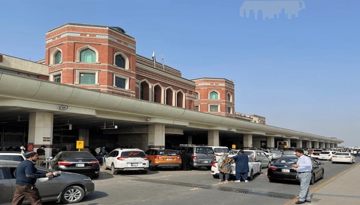 An undated image shows passengers, along with multiple cars at Allama Iqbal International Airport, Lahore. — APP