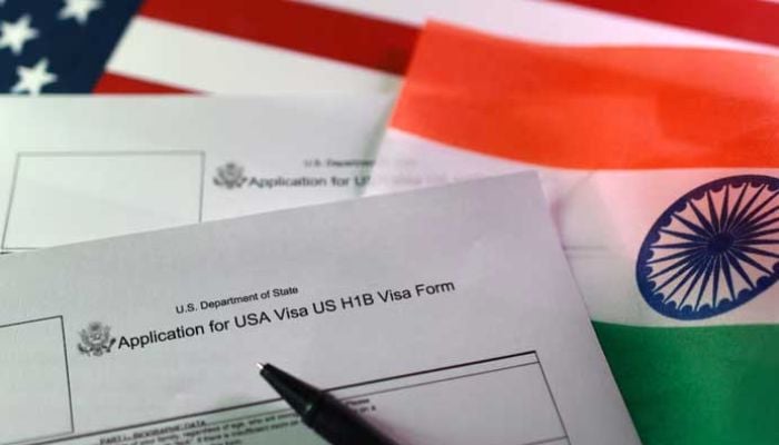 An image of US and Indian flags and H-1B visa application forms is seen in this illustration taken on September 22, 2025. — Reuters