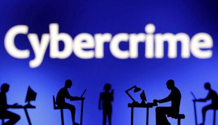 Figurines with computers and smartphones are seen in front of the word Cybercrime in this illustration taken, February 19, 2024. — Reuters