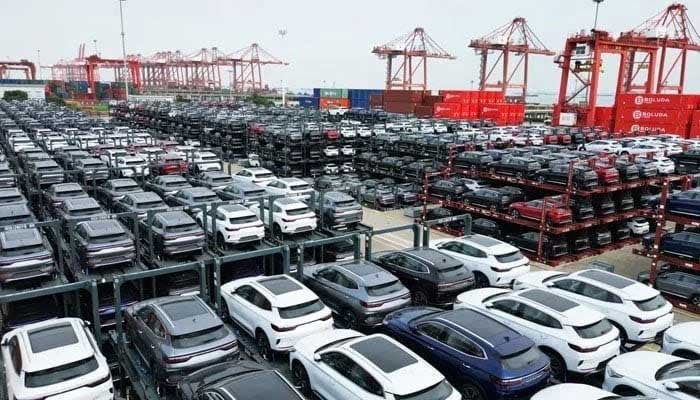 An undated image shows a large number of electric vehicles parked at a port. — AFP