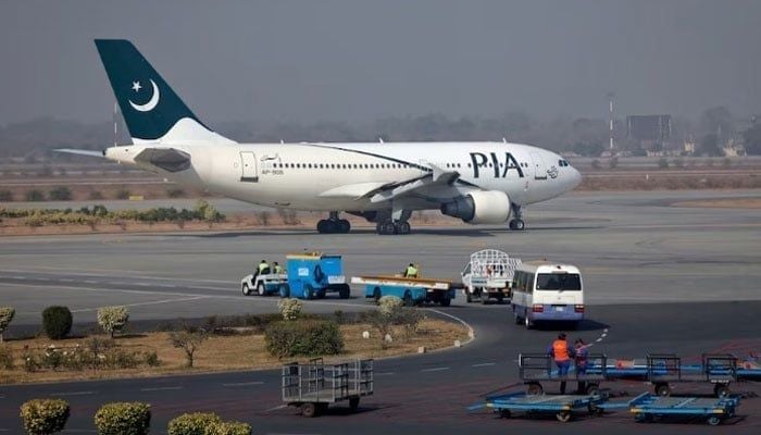 A Pakistan International Airlines (PIA) plane prepares to take off at Allama Iqbal International Airport in Lahore. — Reuters