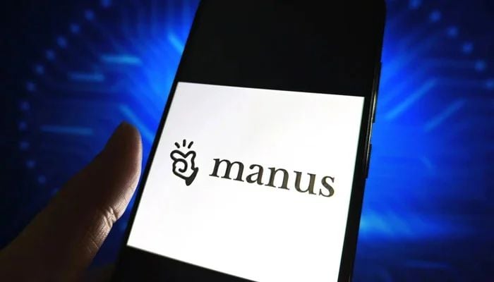 An image of Manus AI logo is displayed on a smartphone screen. — Reuters
