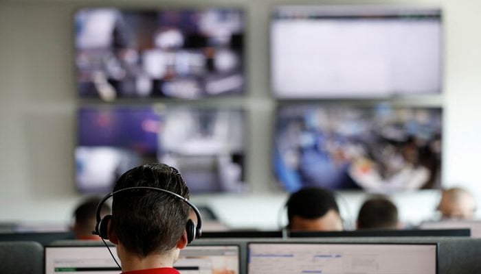 Help-desk staff work at computers in Angers, France, July 3, 2019. — Reuters