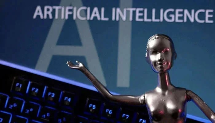 This representational picture shows a metallic figure against a computer. — AFP