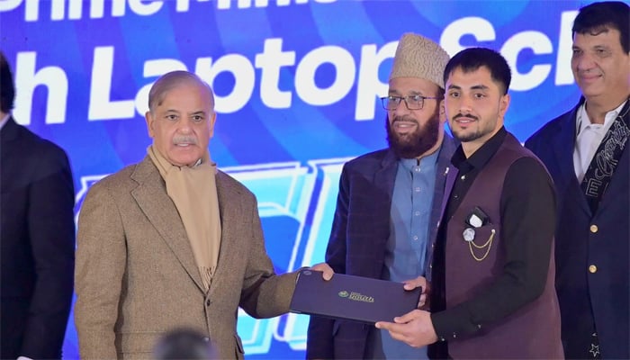 An image shows Prime Minister Muhammad Shehbaz Sharif distributing laptops amongst deserving students of universities of Khyber Pakhtunkhwa (KPK), on December 17, 2025. — Facebook/@GovtofPakistan