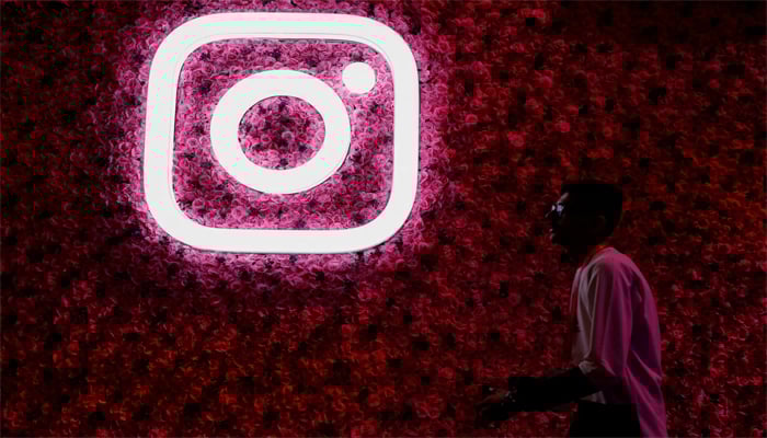 A man walks past a logo of mobile application Instagram, during a conference in Mumbai, India, September 20, 2023. — Reuters