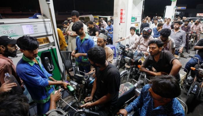 People wait their turn to get fuel at a petrol station, in Karachi, Pakistan June 2, 2022. — Reuters