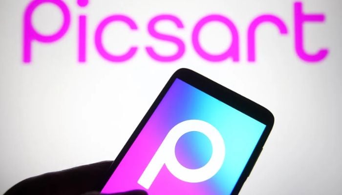 An undated image shows Picsart logo on a smartphone, and Picsart written in the background. — Getty Images