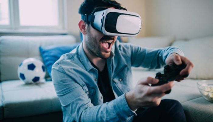 An undated image shows a person playing VR games. — iStock