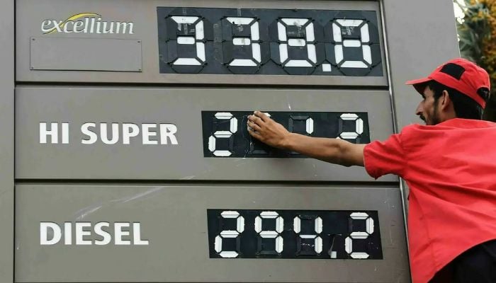 An employee updates the fuel prices at a fuel station in Karachi on August 16, 2024 in this file photo. — AFP