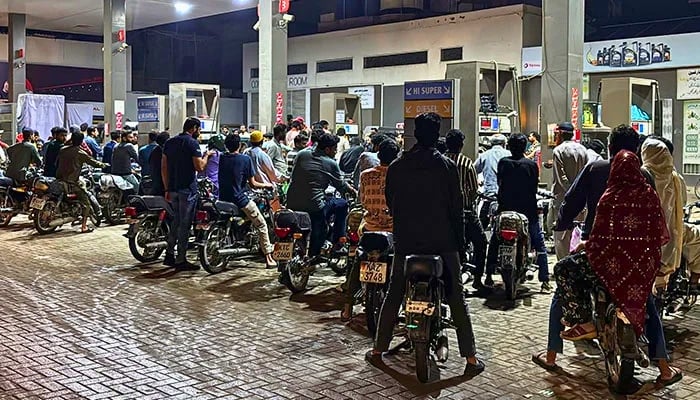 People on their vehicles wait for their turn to get fuel at a petrol station, as fuel prices in Pakistan rise, amid the US-Israeli conflict with Iran, in Karachi, Pakistan, April 2, 2026. — Reuters